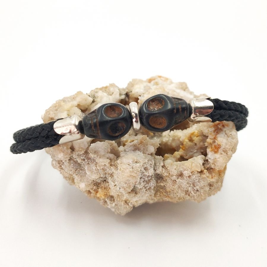 Armband med dubbla dödskallar och korsben med svarta stenar på dubbla rep